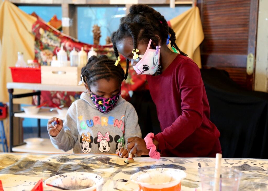 two girls creating art at Betty Brinn Children's Museum Milwaukee Wisconsin